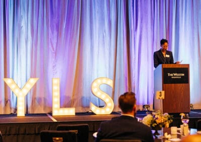 erica mitchell giving opening remarks at networking over nashville event