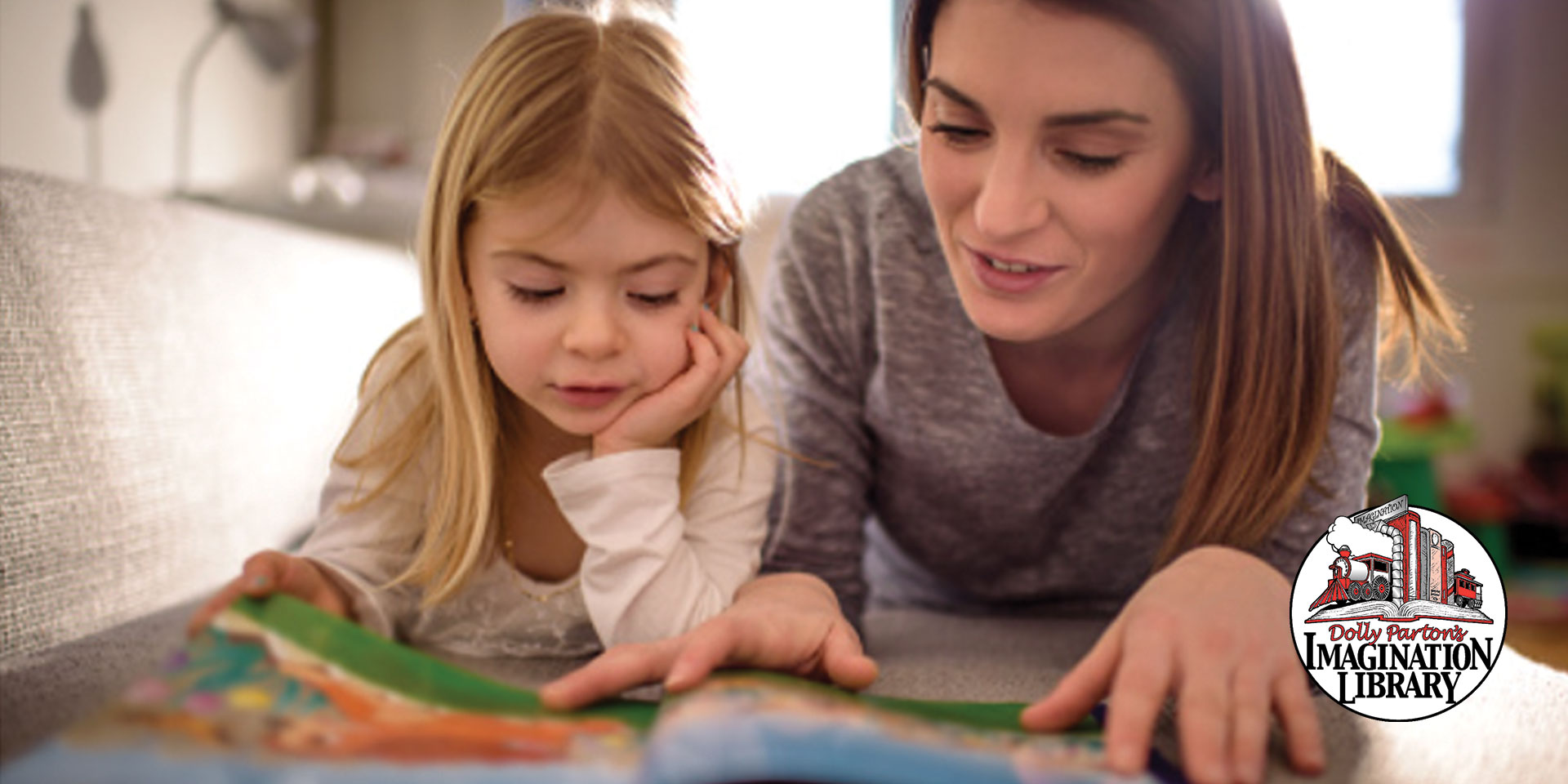 mother reading to young daughter